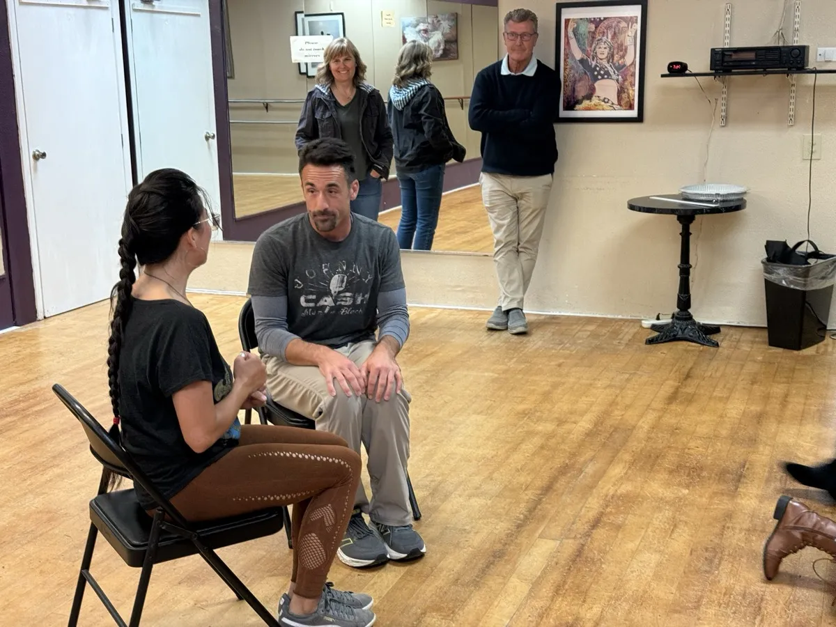Two Improv Playground participants sharing a genuine hug after class