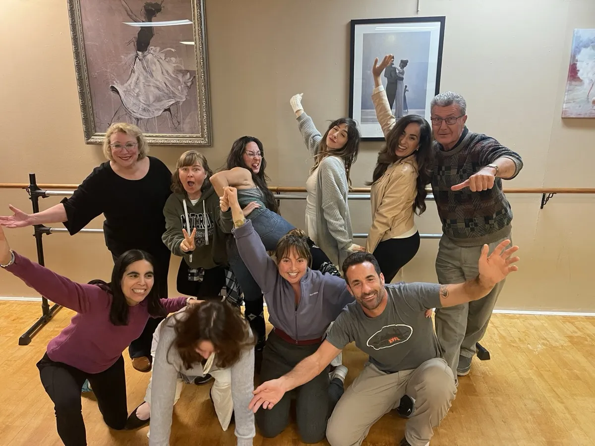 Workshop participant with arms wide open, mid-expression of joy and creativity